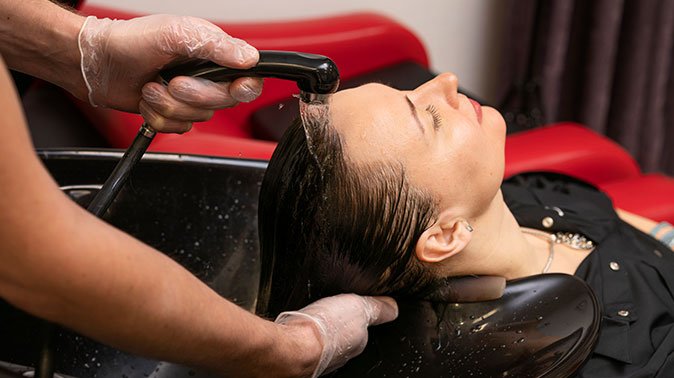 hairdresser washing woman s hair