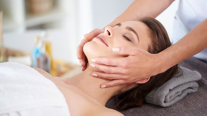 young female receiving professional facial massage